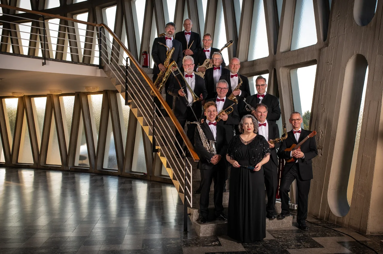 Bigband mit Instrumenten auf einer Treppe in moderner Betonarchitektur